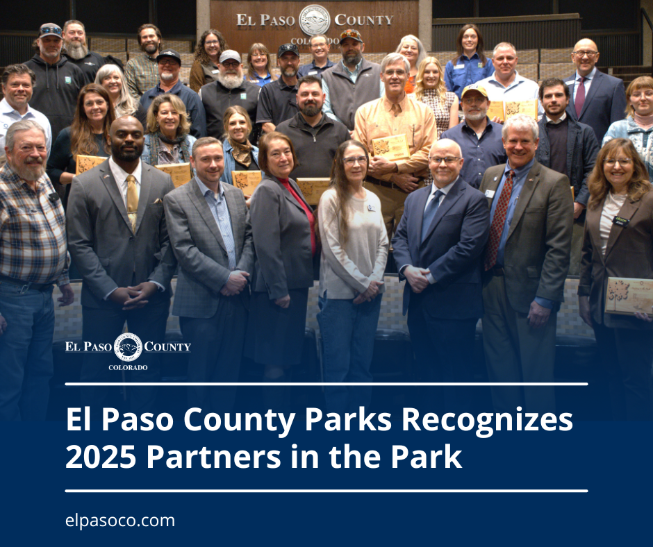 Graphic with a photo of a group of people who are the 2025 El Paso County Partners in the Park with a blue transparent overlay at the bottom and text reading El paso County Parks Recognizes 2025 Partners in the Park