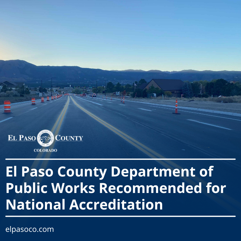 Early morning scene of the mountains with a freshly paved roadway and safety cones featured in the foreground, with text overlaid: El Paso County Department of Public Works Recommended for National Accreditation