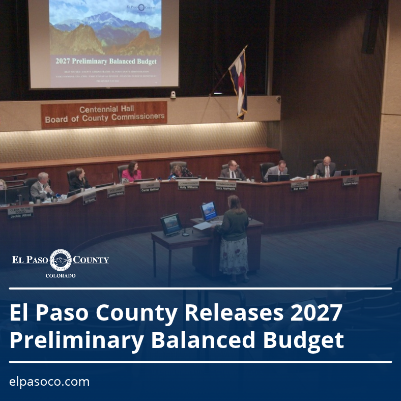 El Paso County Board of County Commissioners meeting in Centennial Hall during a presentation of the 2027 Preliminary Balanced Budget. Text on the graphic reads, “El Paso County Releases 2027 Preliminary Balanced Budget” and “elpasoco.com.”