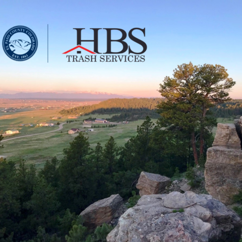 Photo of Homestead Ranch regional Park looking towards the mountain with logo lockup overlay of El Paso County Logo and HBS Trash Services