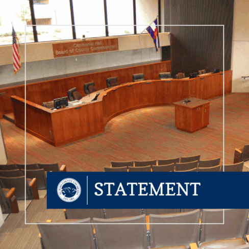 square graphic with photo of the inside of the El Paso County Auditorium where the Board of Commissioners meet.