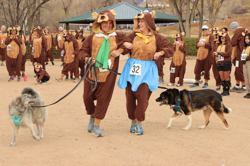 Two people in bear costumes dancing