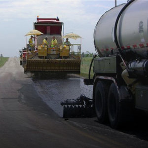 El Paso County, CO, roadway project Two large roadway trucks perform maintenance to a road