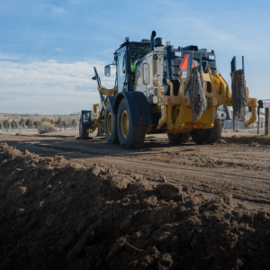 El Paso County grader on a dirt road