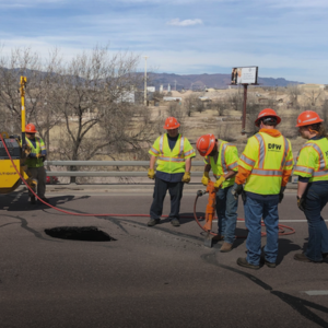 Public Works Road Maintenance El Paso County Public Works team members are working on a maintenance road project fixing pavement around a road pothole.