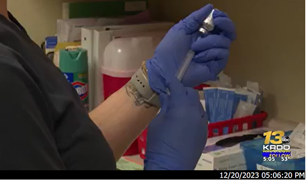 Picture of a healthcare worker holding syringe.