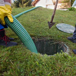 OWTS Resources a person is using a hose to clean out a hole in the ground