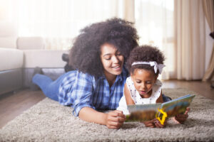 Mother reading a book to a small child