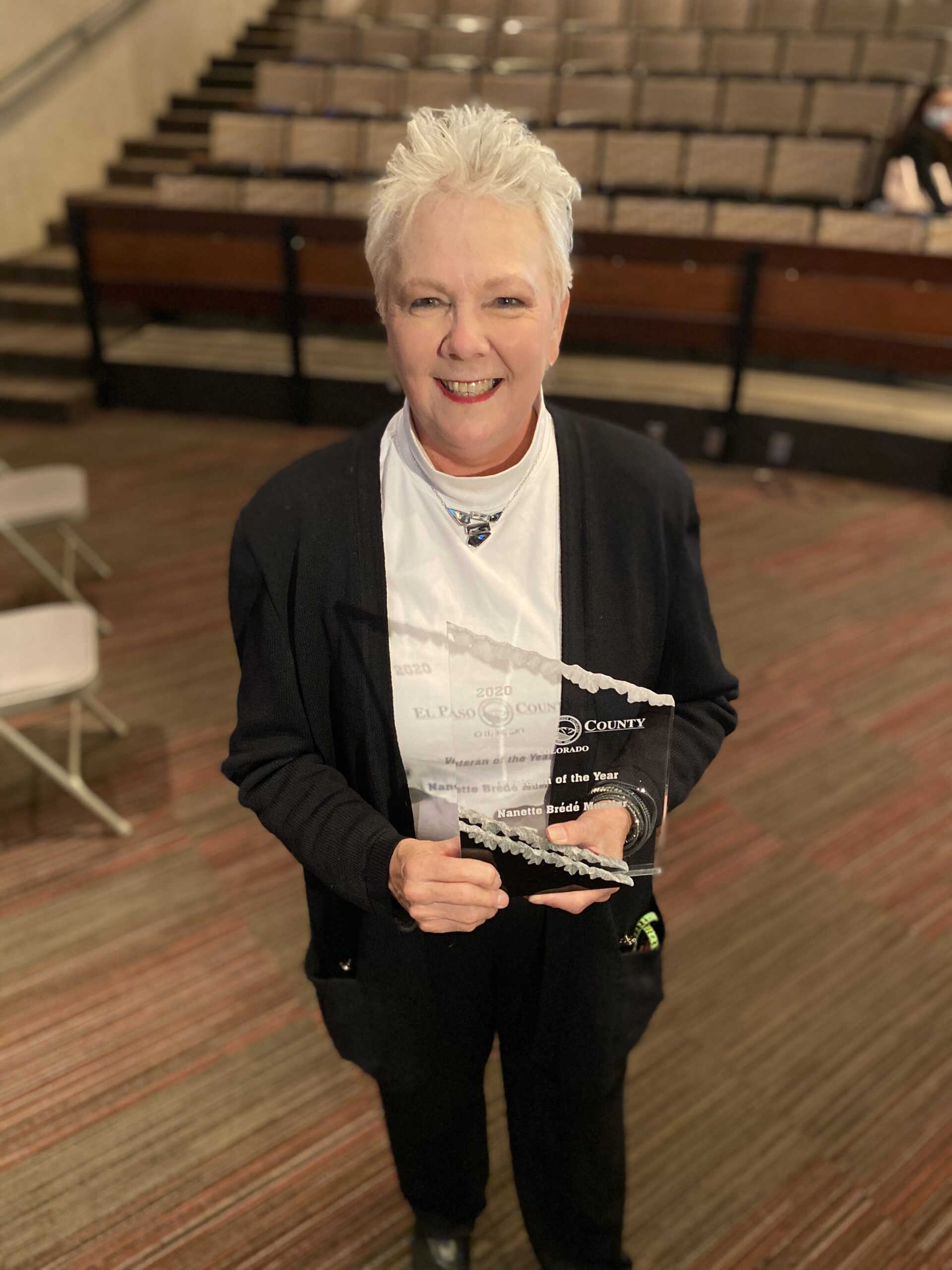 Nanette Brédé Mueller Holds Her 2020 Veteran of the Year Award