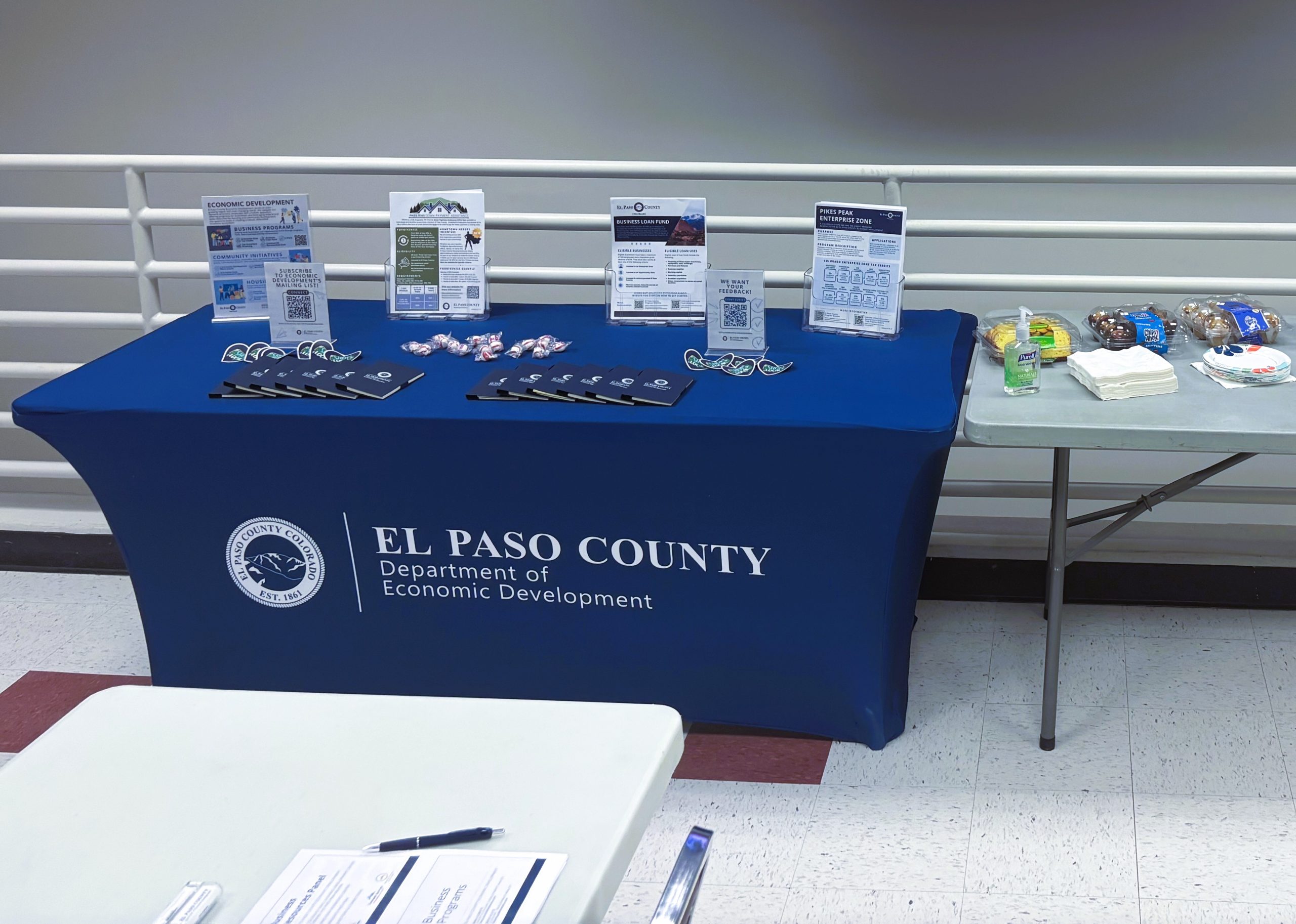 Attendees enjoy complementary coffee, treats, and resources at the event.