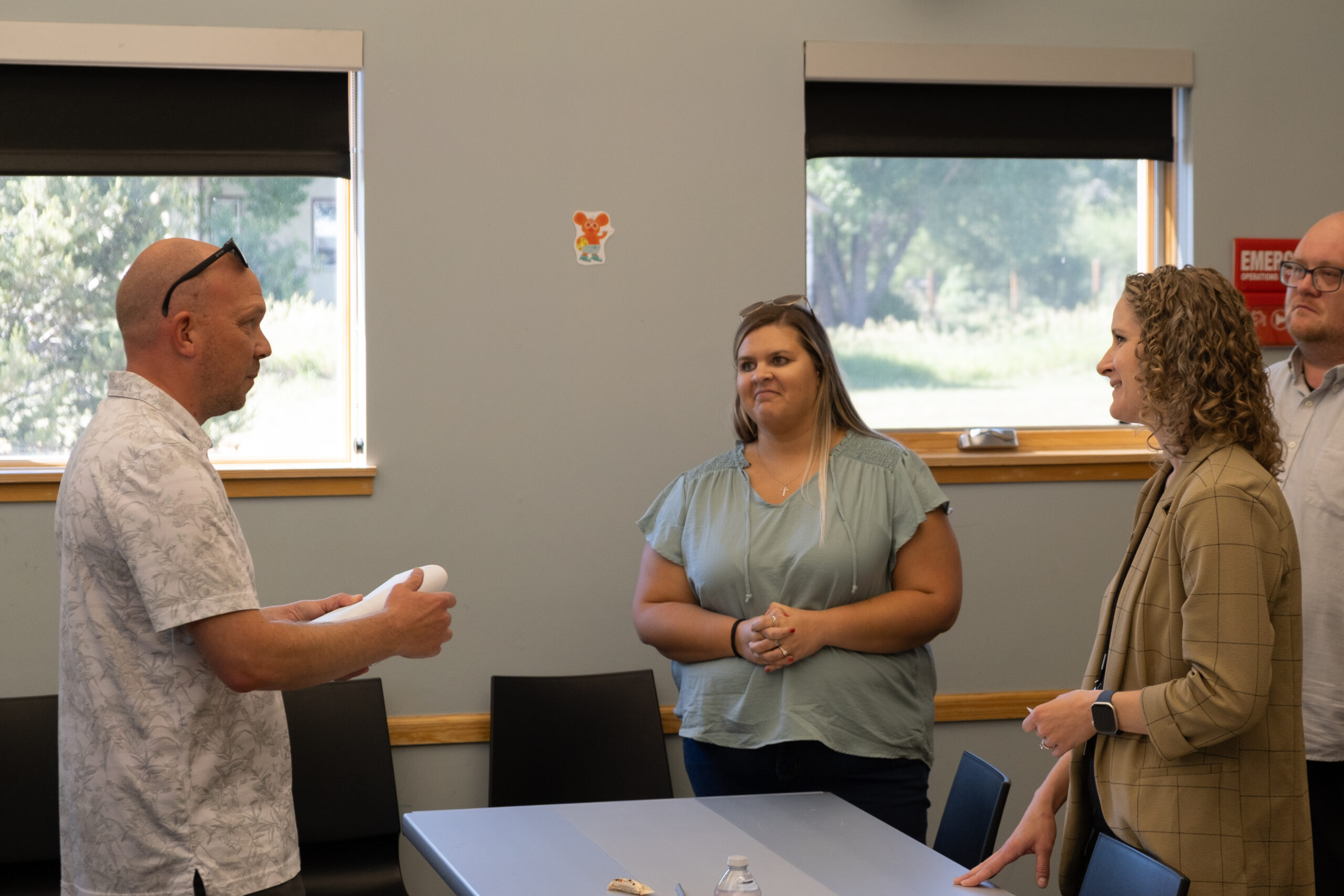 Attendees discuss business resources at the High Prairie Library event.