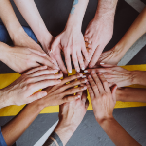 image of hands joining in the middle of the photo