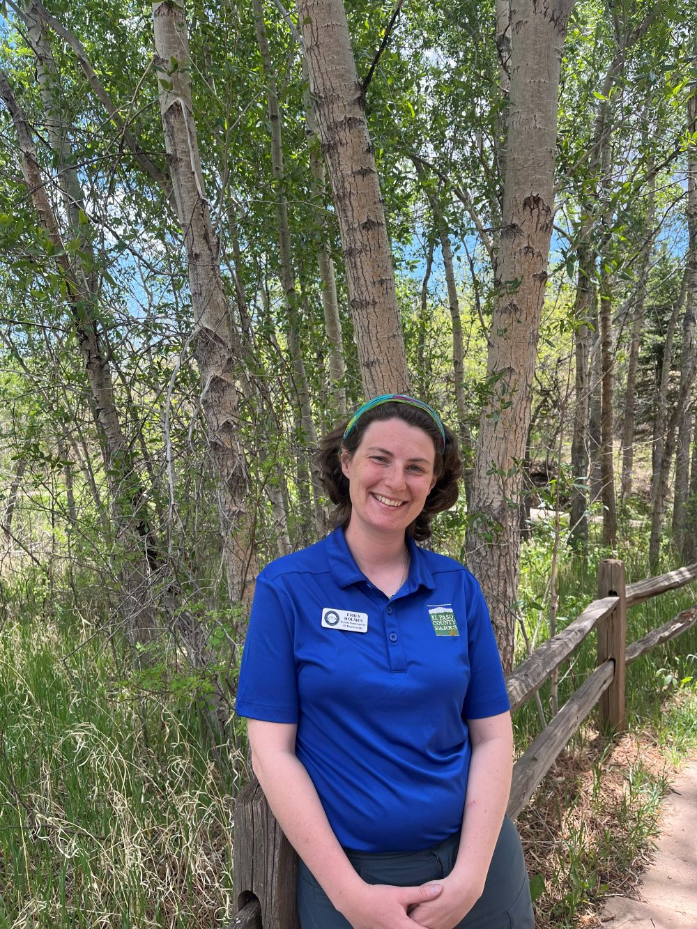 20260516_184246336_iOS Staff member Emily Holmes stands in front of trees