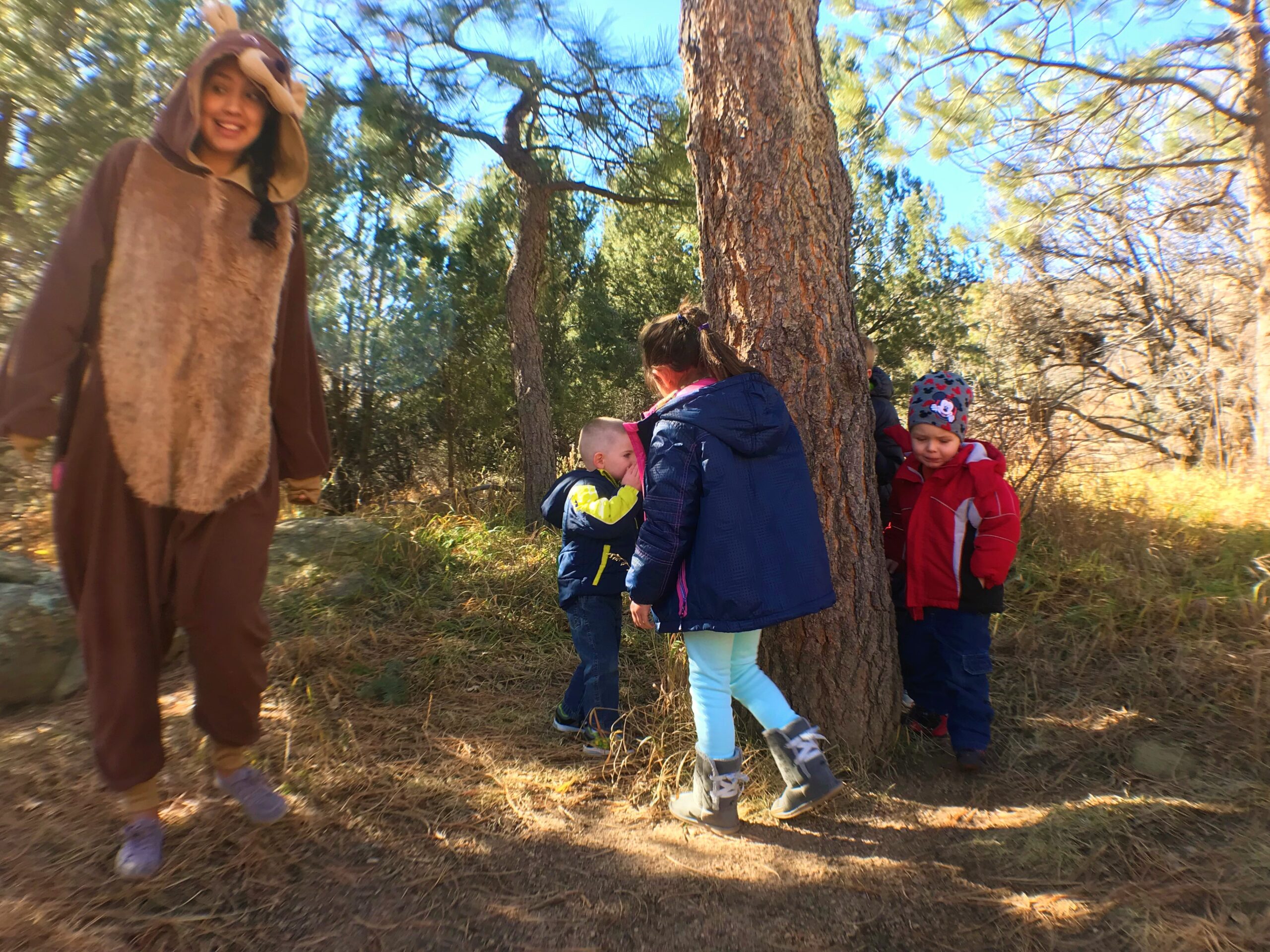 Children take a sniff of the candy tree during an All About Bears birthday party