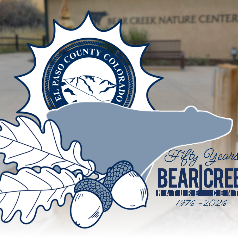 Logo in foreground depicting El Paso County logo wthin a sun, the silhouette of a bear and the text Fifty Years Bear Creek Nature Center 1976-2026. Bear Creek Nature Center building in the background