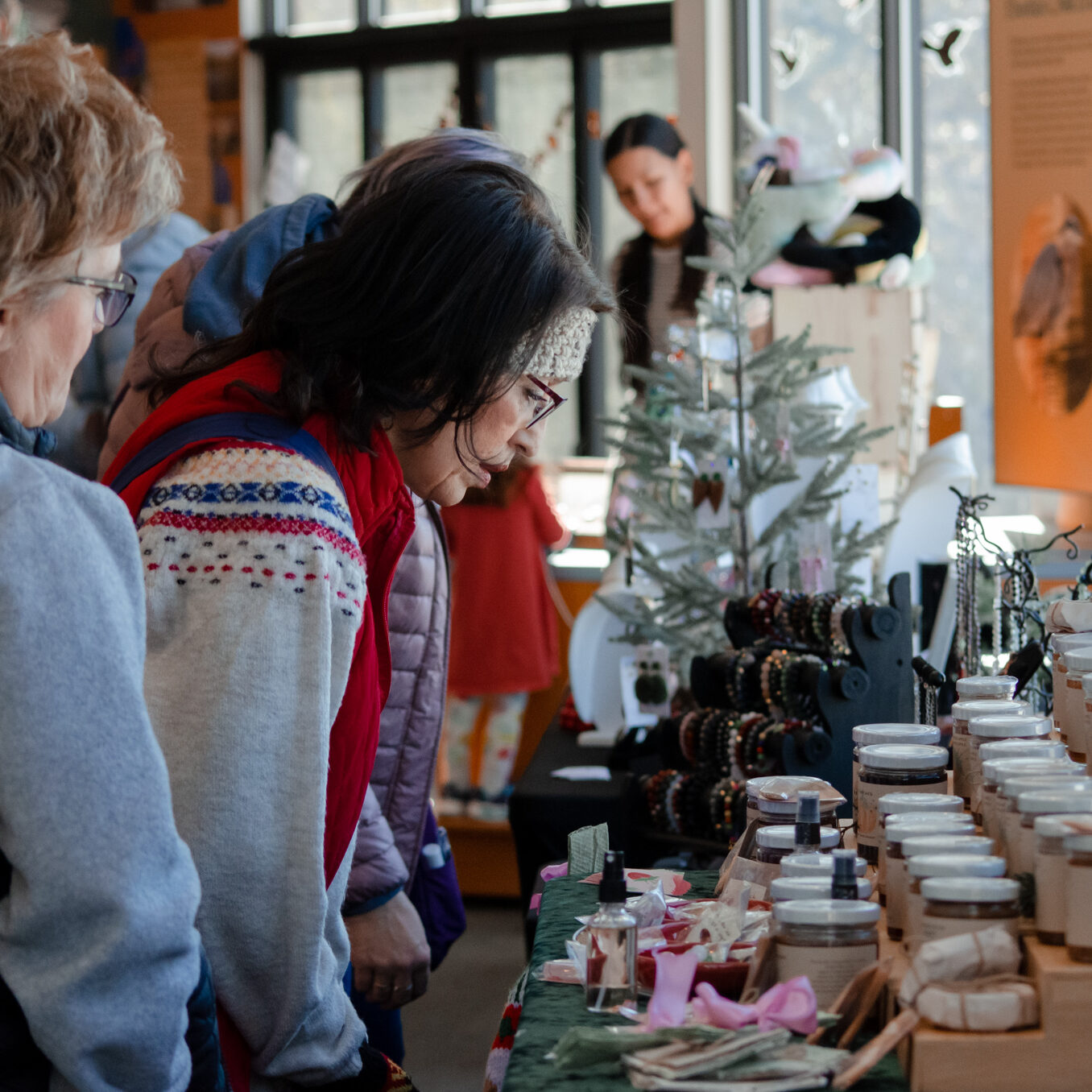 A shopper looks closely at jams and spreads.