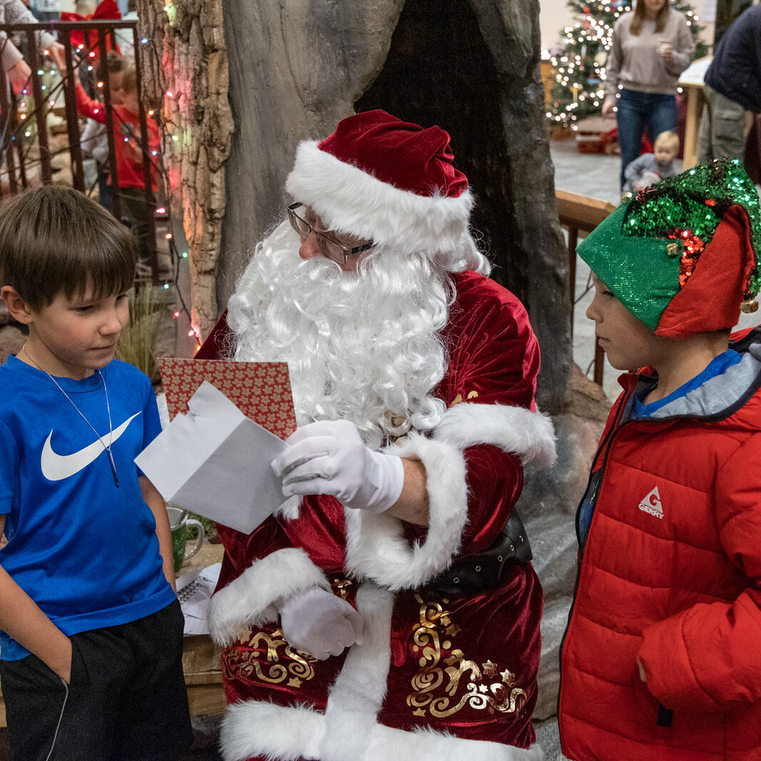 Santa talks to two young boys about their wishlist.