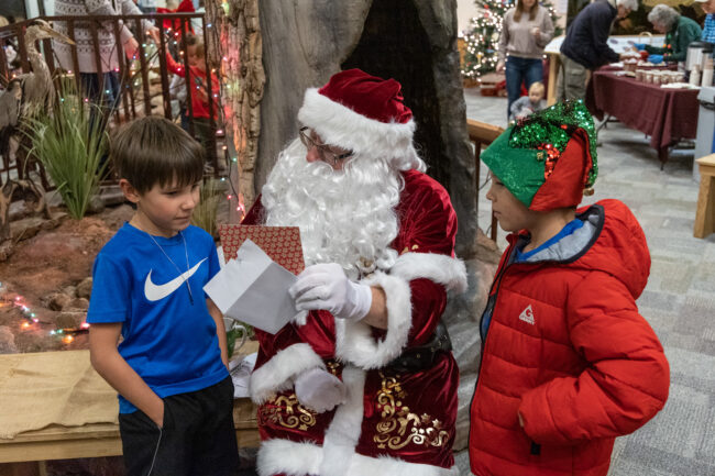 Santa talks to two young boys about their wishlist.
