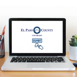 Laptop open displaying an El Paso County, Colorado logo and submit graphic
