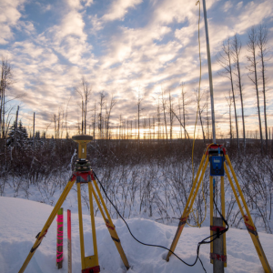 Survey equipment set up in snow at sunset Canada